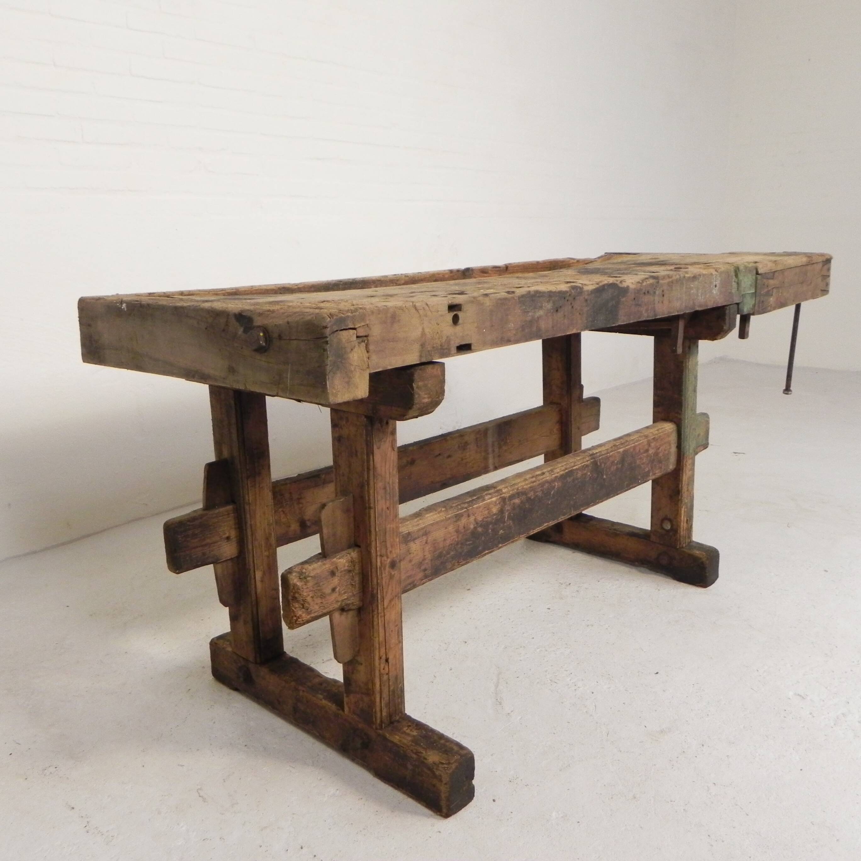Wooden industrial workbench with vice, 194 cm long, 1930s.