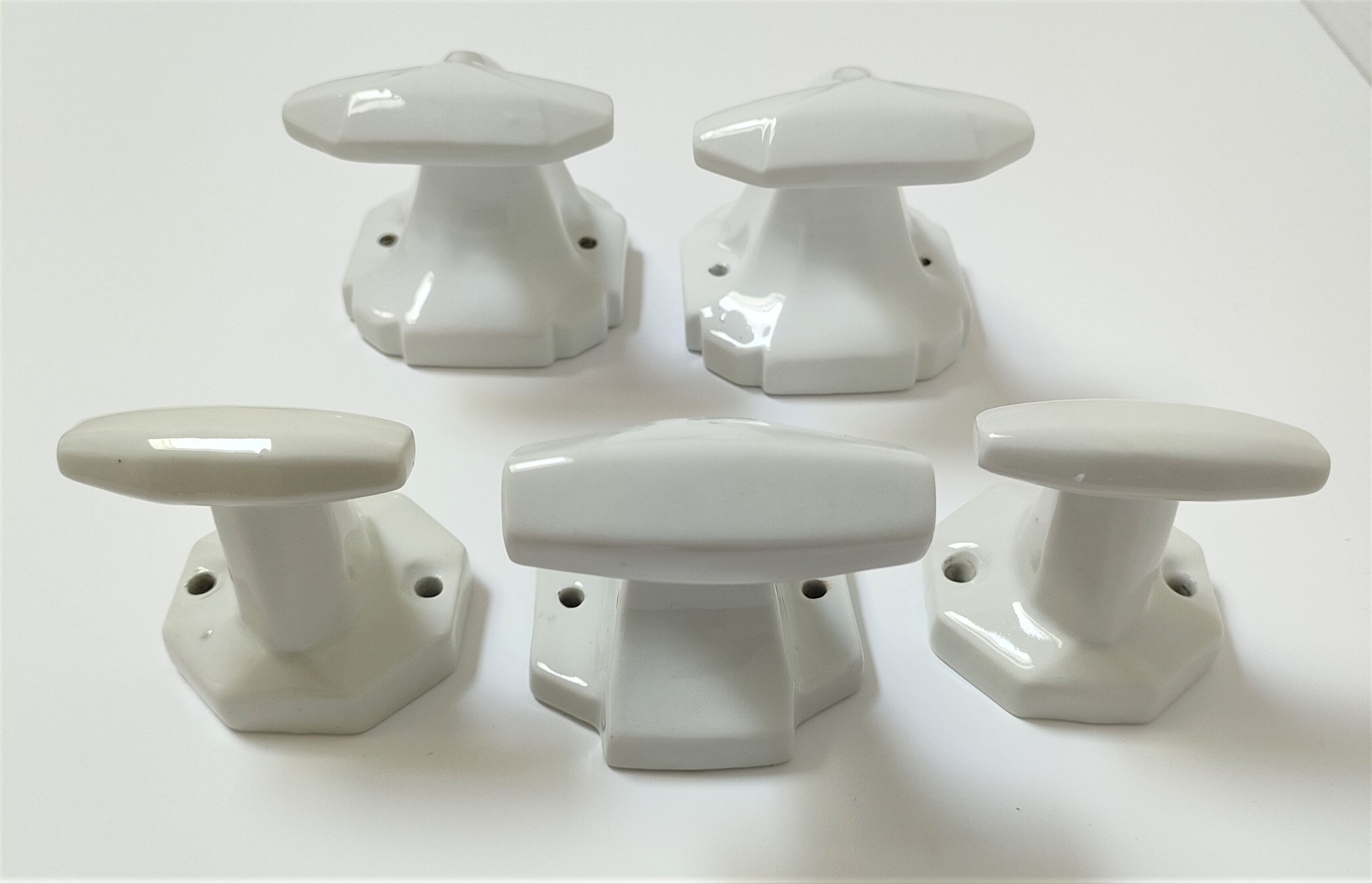 Five art deco white porcelain hooks