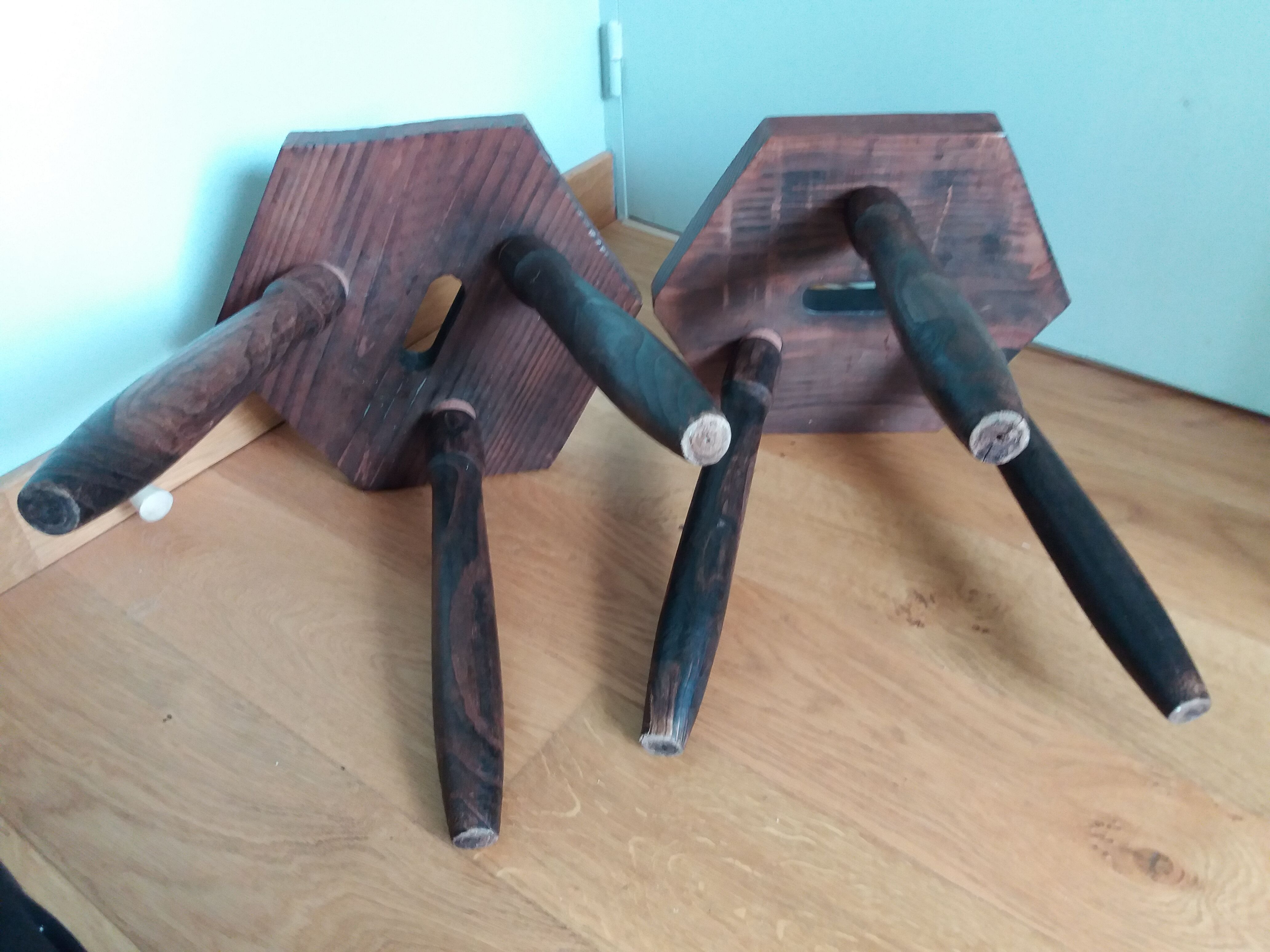 2 wooden tripod stools