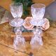 Cut crystal white wine glasses with a slender baluster-shaped stem.