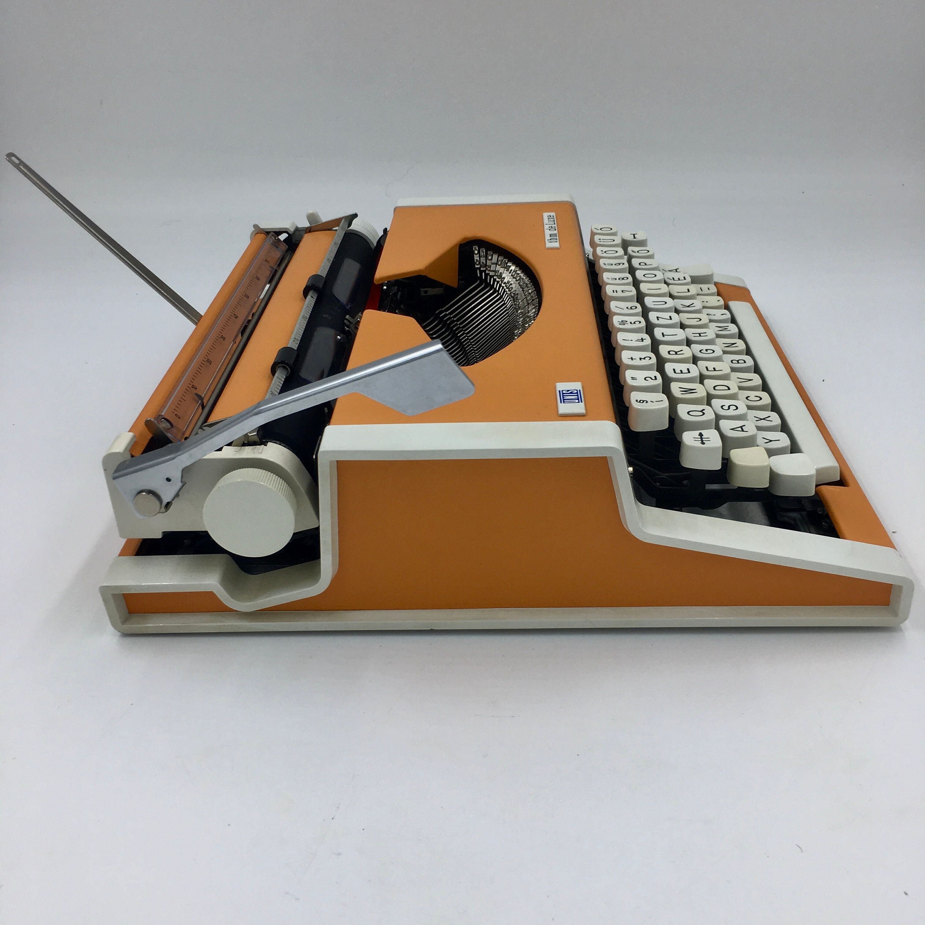 WE typewriter orange