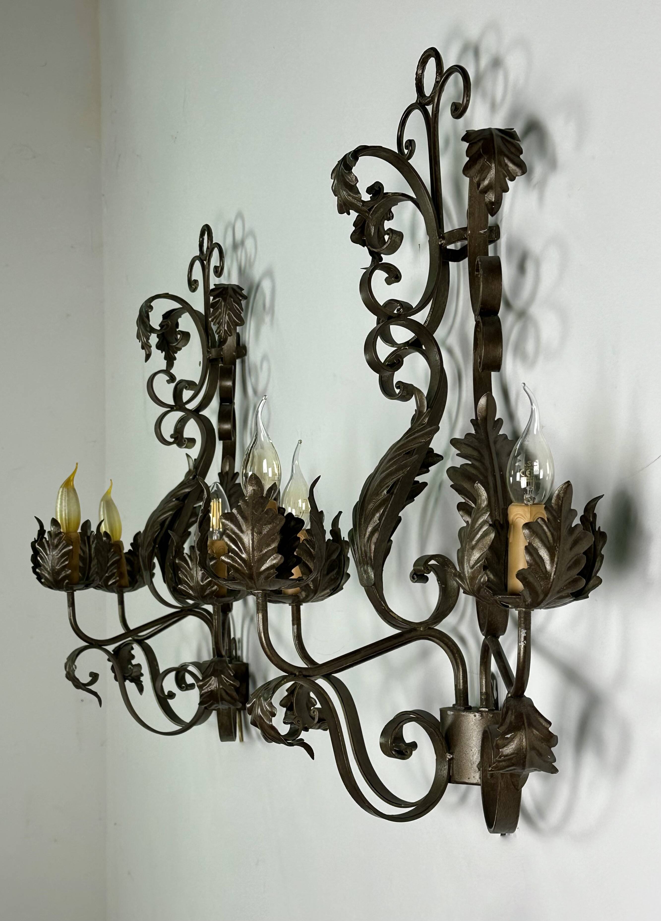 Wrought iron wall lights (pair) with foliage decoration
