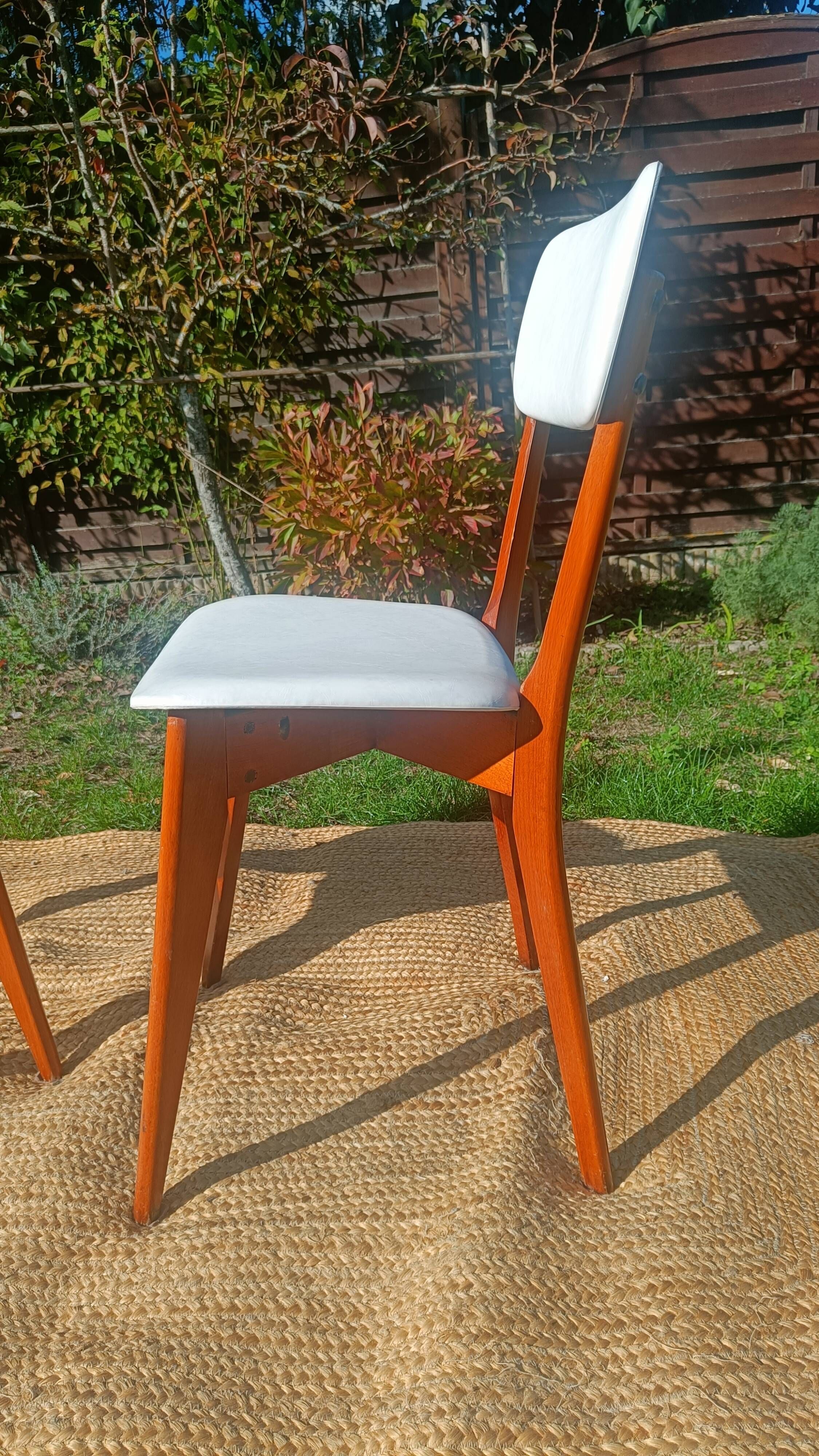 vintage wooden chairs with white faux leather