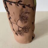 Artisanal pottery set in red clay with harmonious plant motifs