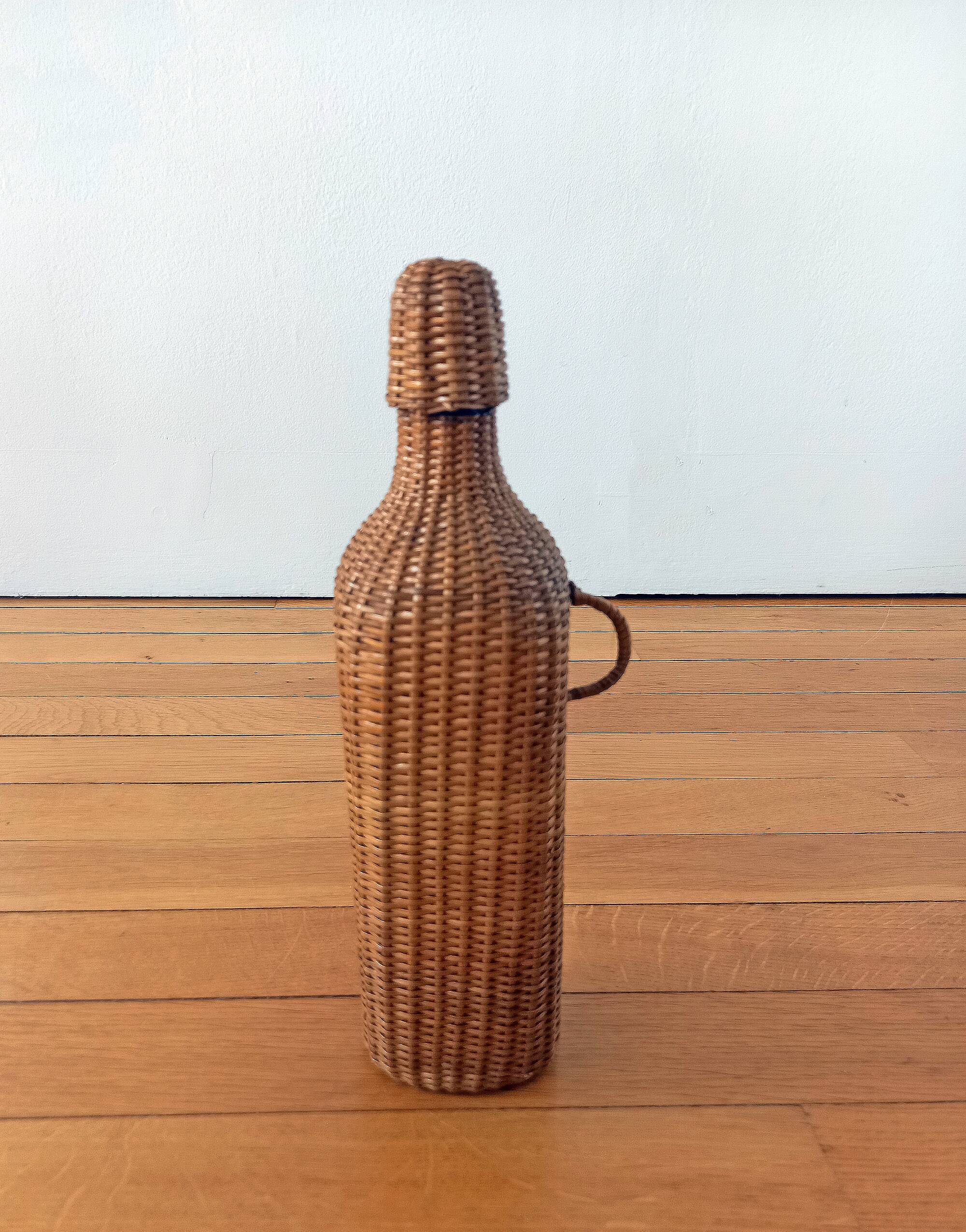 Bottle, old carafe in glass and wicker, 1950s