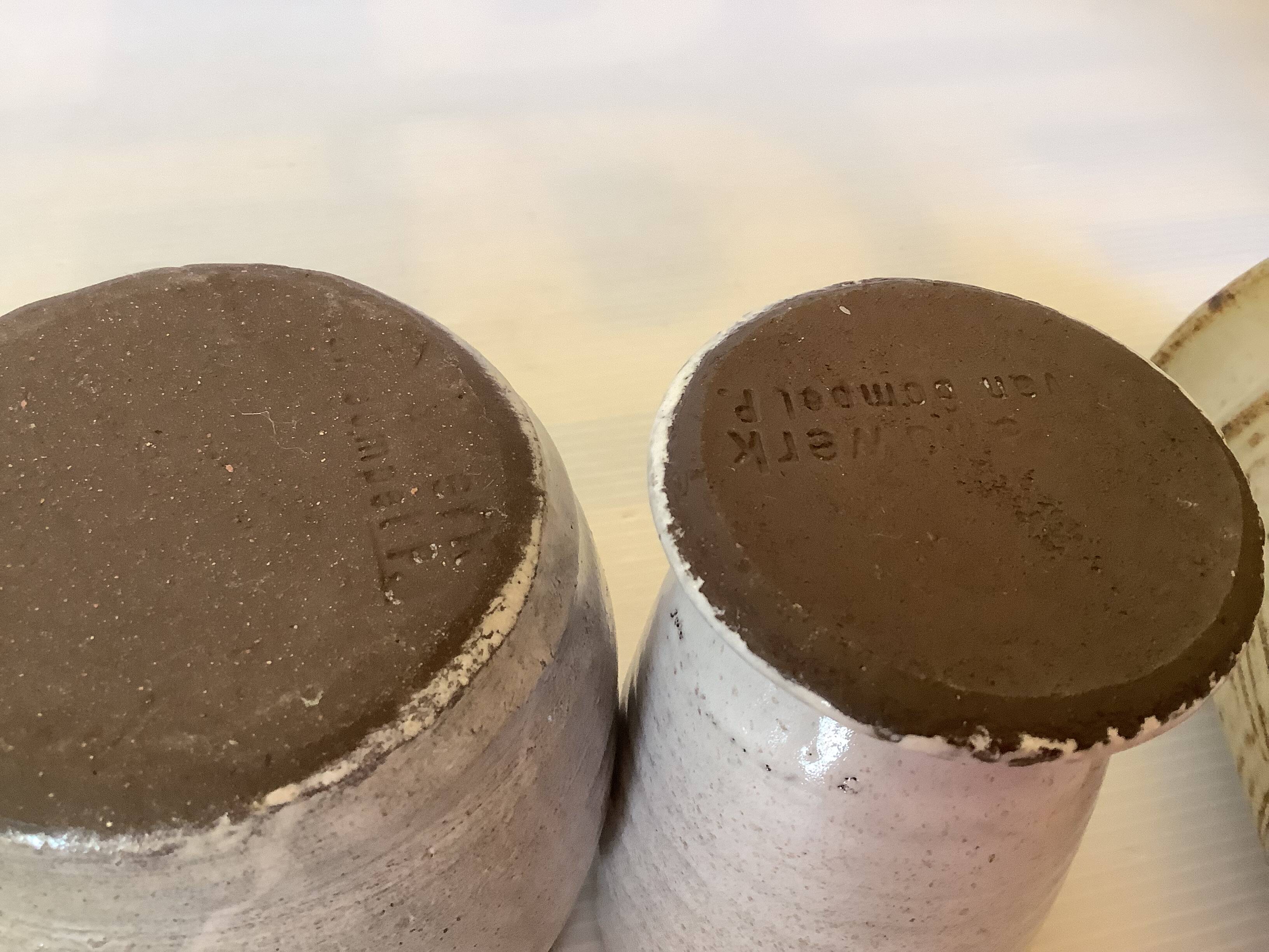 Seven beige and gray ceramic vases