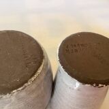 Seven beige and gray ceramic vases