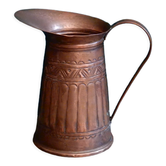 Old hand-chiseled copper pitcher