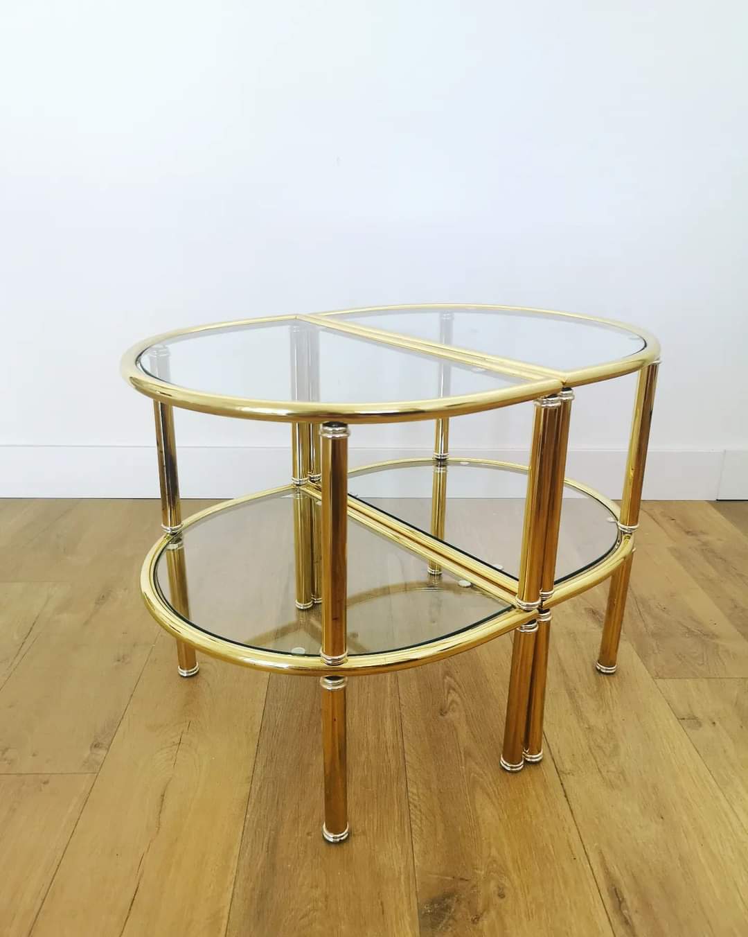 Pairs of gilded metal bedside tables and glass tops