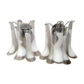 Wall sconces in white and transparent murano glass "saddle"