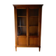 Straight molded clear wood cornice cabinet opening to two glass doors resting on  four sheath feet.
