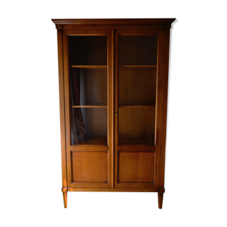 Straight molded clear wood cornice cabinet opening to two glass doors resting on  four sheath feet.
