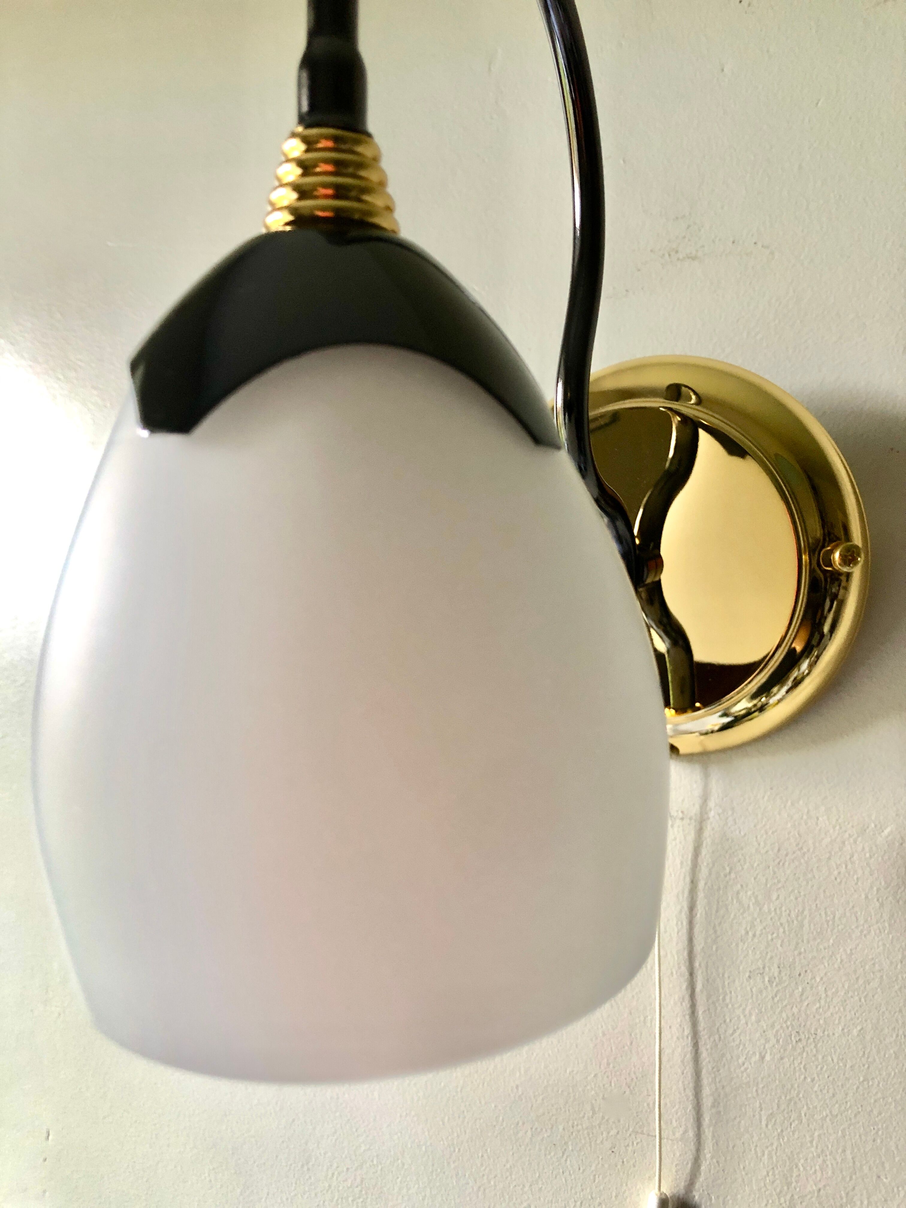 Black and gold wall light with white opaline flower, Italy 1990.