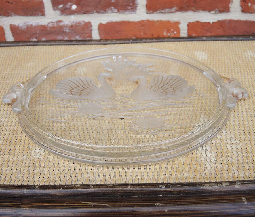 Vintage glass cake stand with swan decoration.