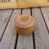 Brown sandstone cup with white spots