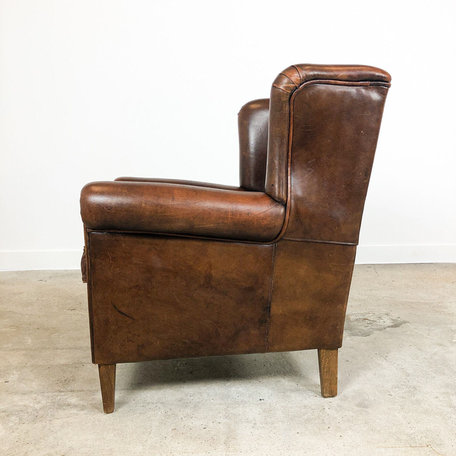 Dark brown sheep leather wingback armchair