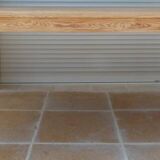 Large natural wood table with rectangular top supported by legs