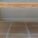 Large natural wood table with rectangular top supported by legs