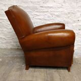 Antique club chair with mustache back