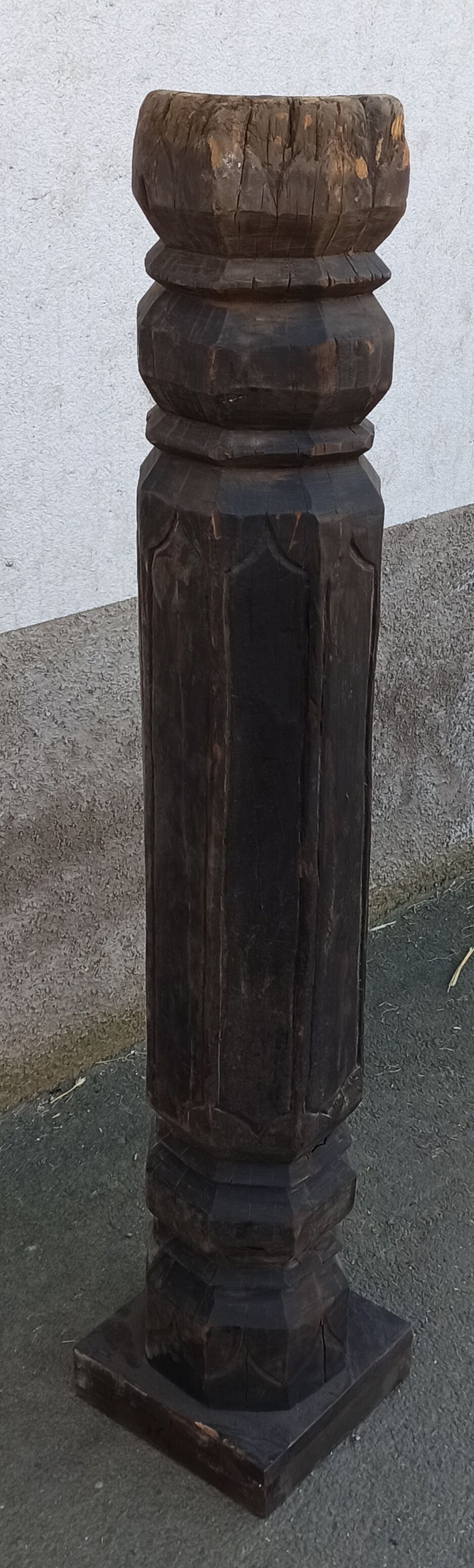 Old wooden pillar on pedestal