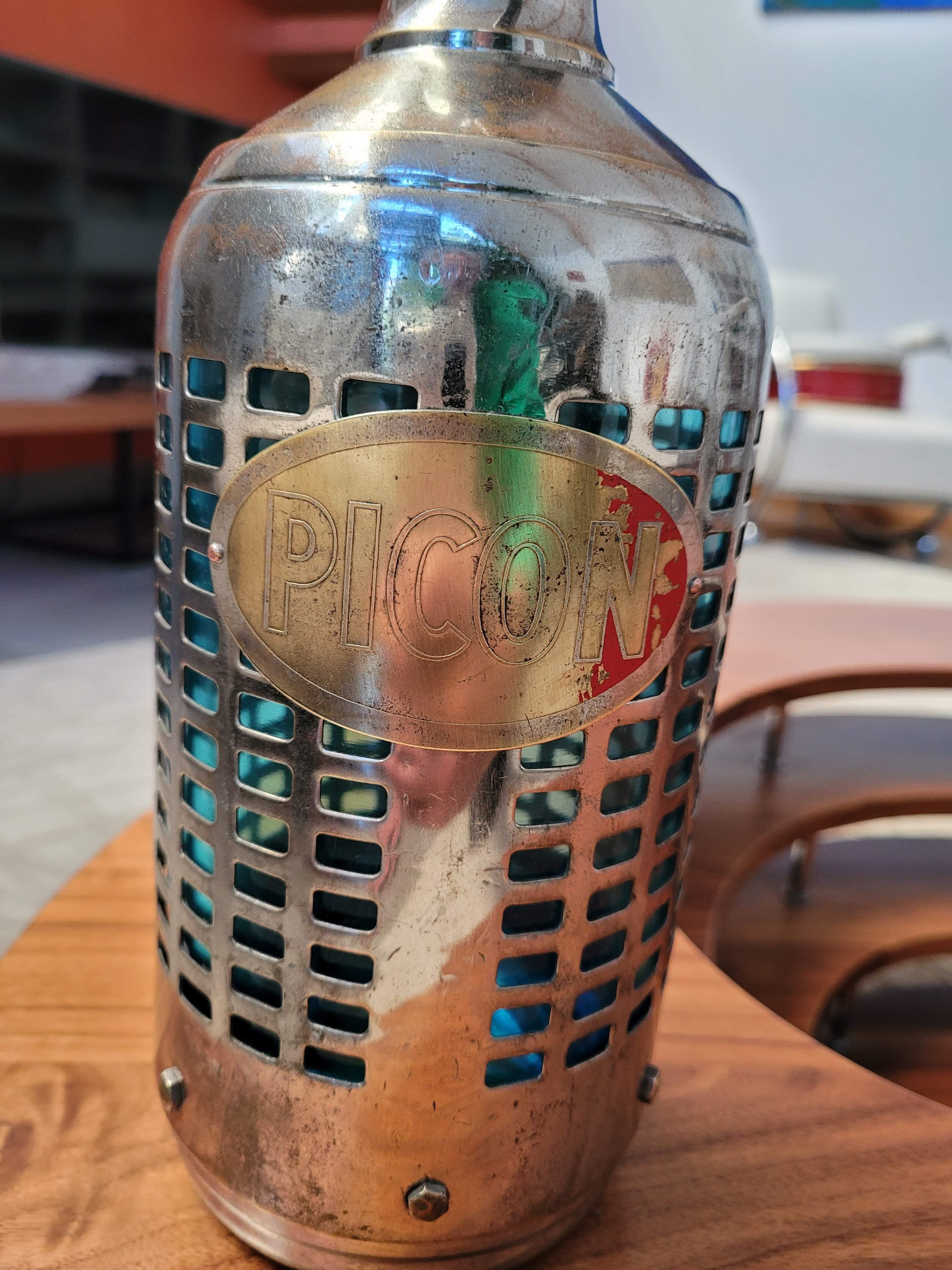 Seltzer water siphon in its protective grid