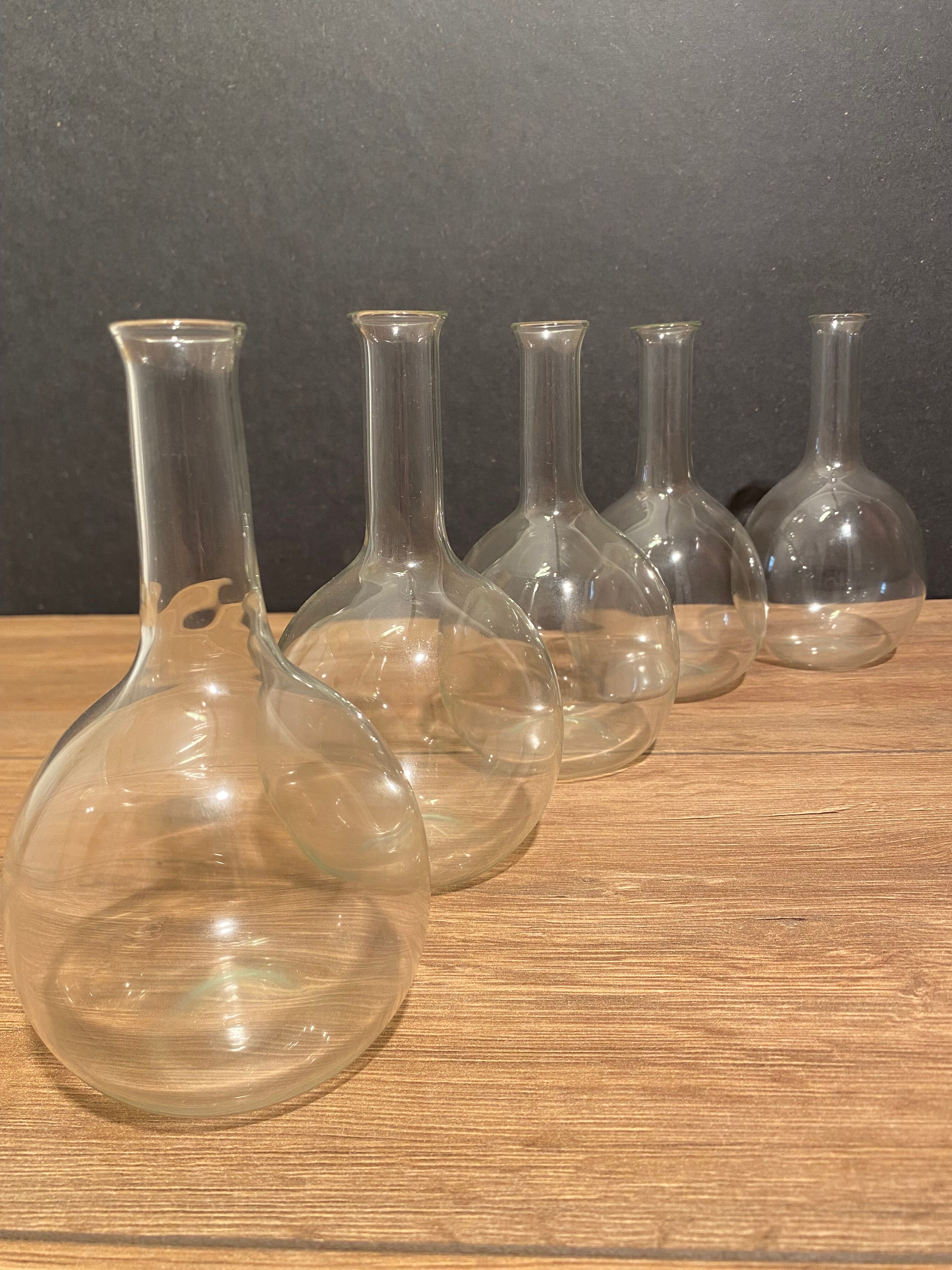 Suite of 5 bakings, bottles with long glass neck