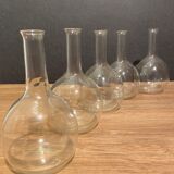 Suite of 5 bakings, bottles with long glass neck