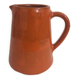 Orange glazed ceramic pitcher