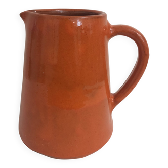 Orange glazed ceramic pitcher