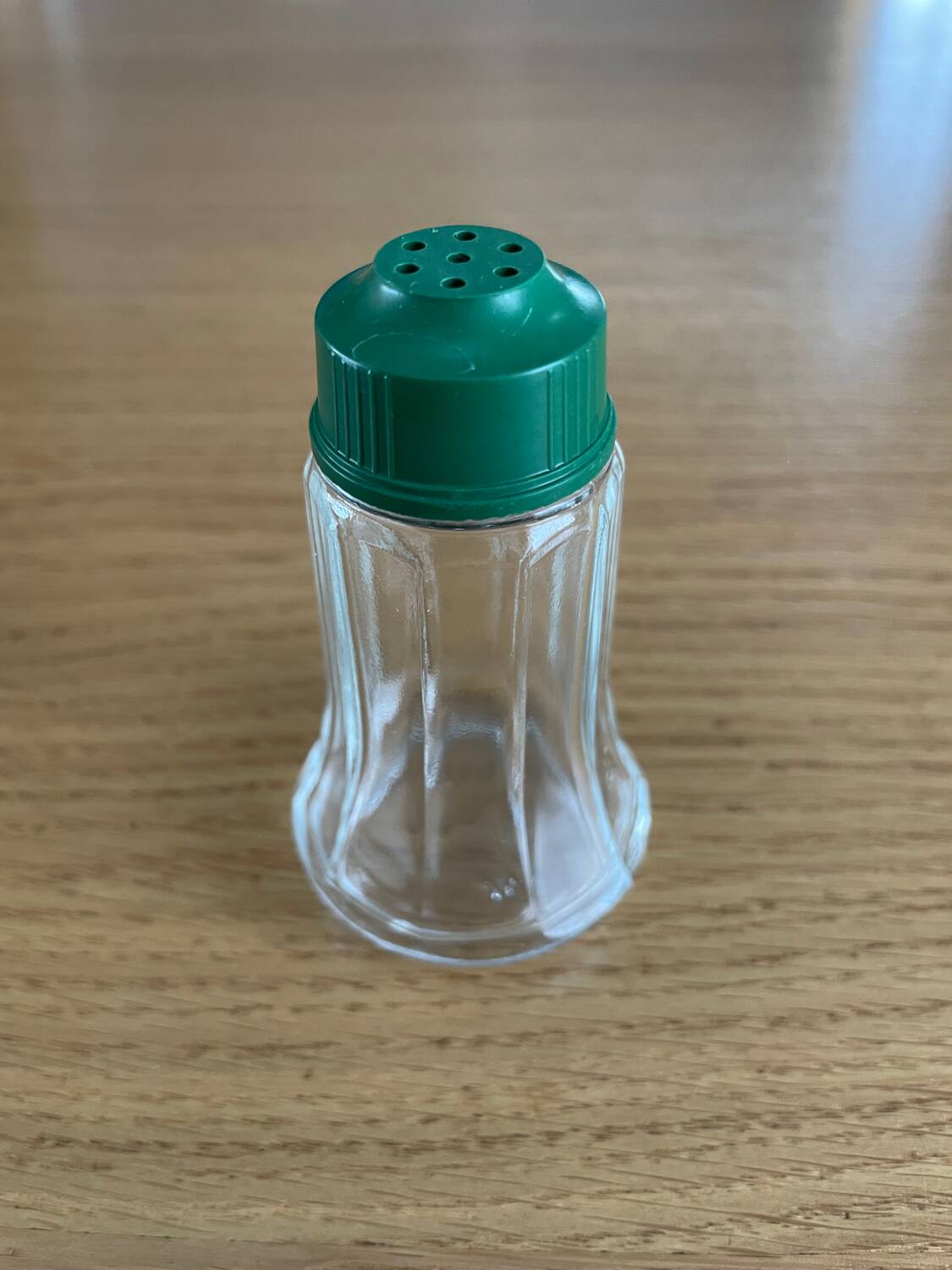 Vintage salt shaker with green Bakelite cap
