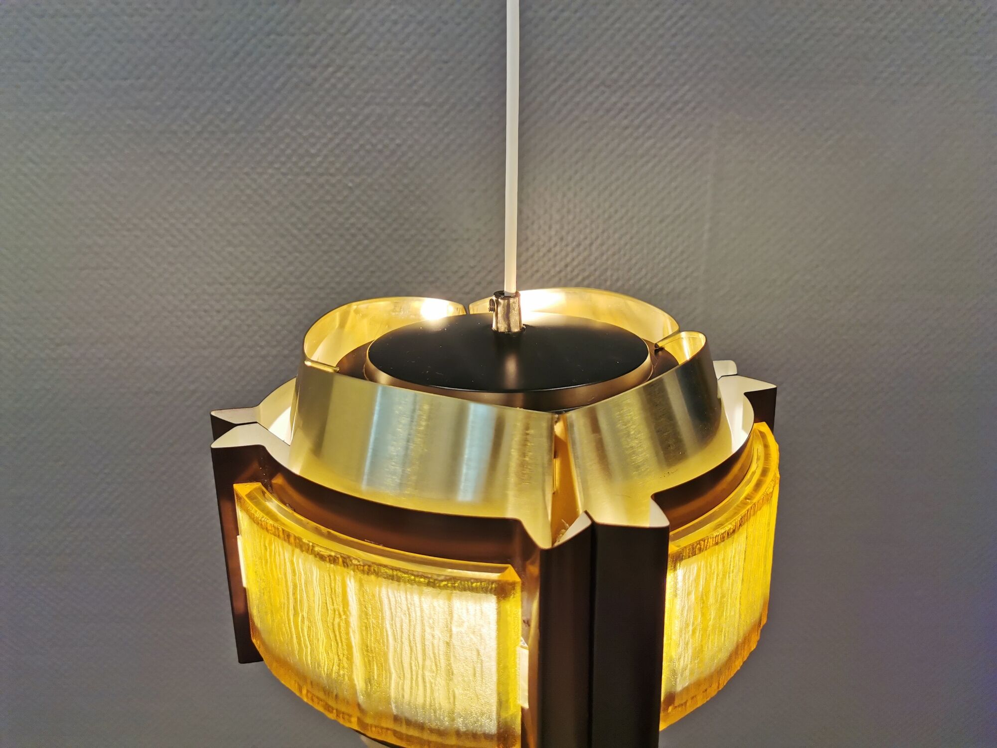 Danish hanging lamp, made in brass colored and brown metal, with yellowish hard pressed plastic deta