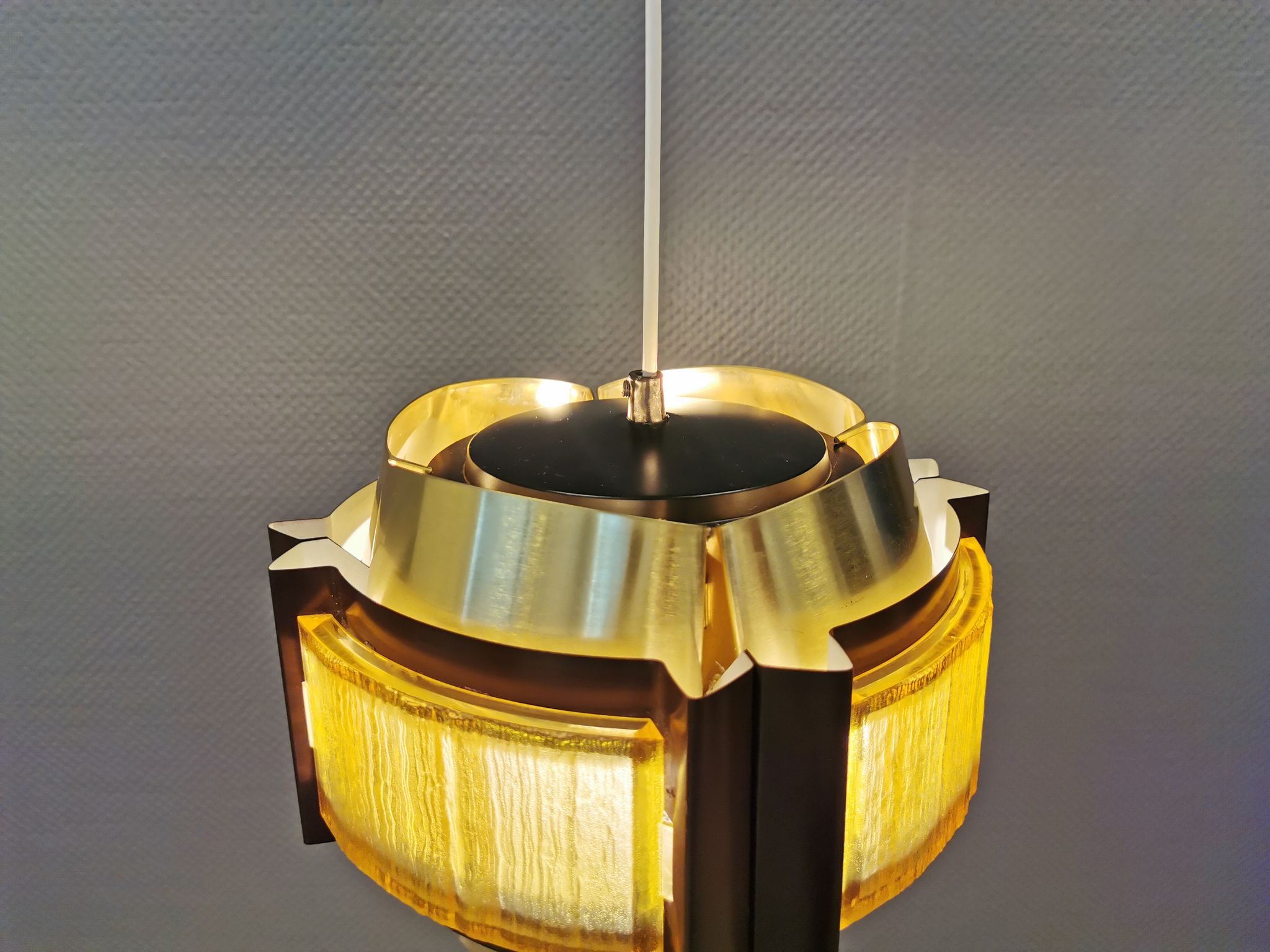 Danish hanging lamp, made in brass colored and brown metal, with yellowish hard pressed plastic deta