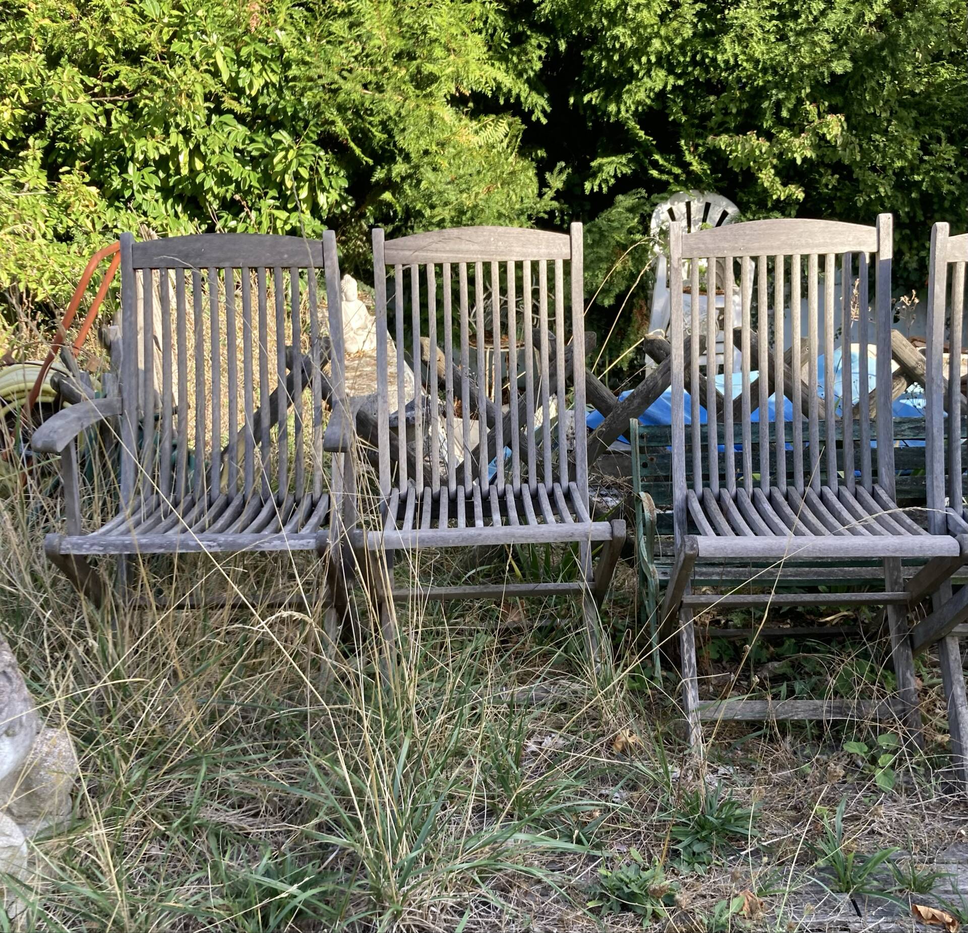 Folding garden chairs and armchairs in River Han dowelled teak.