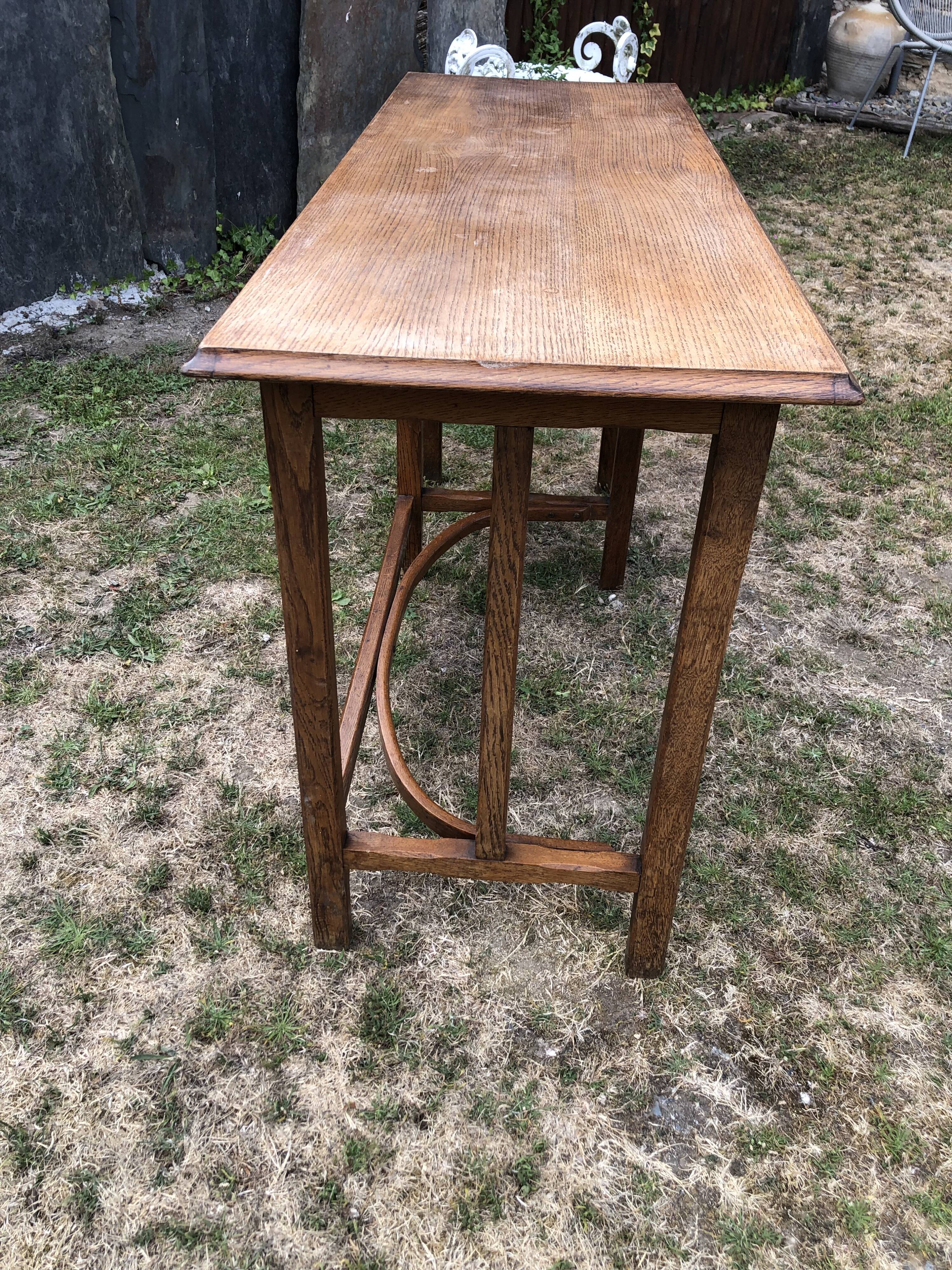 Old oak desk with curved wooden sleepers in the Art Nouveau spirit of the early 20th century.