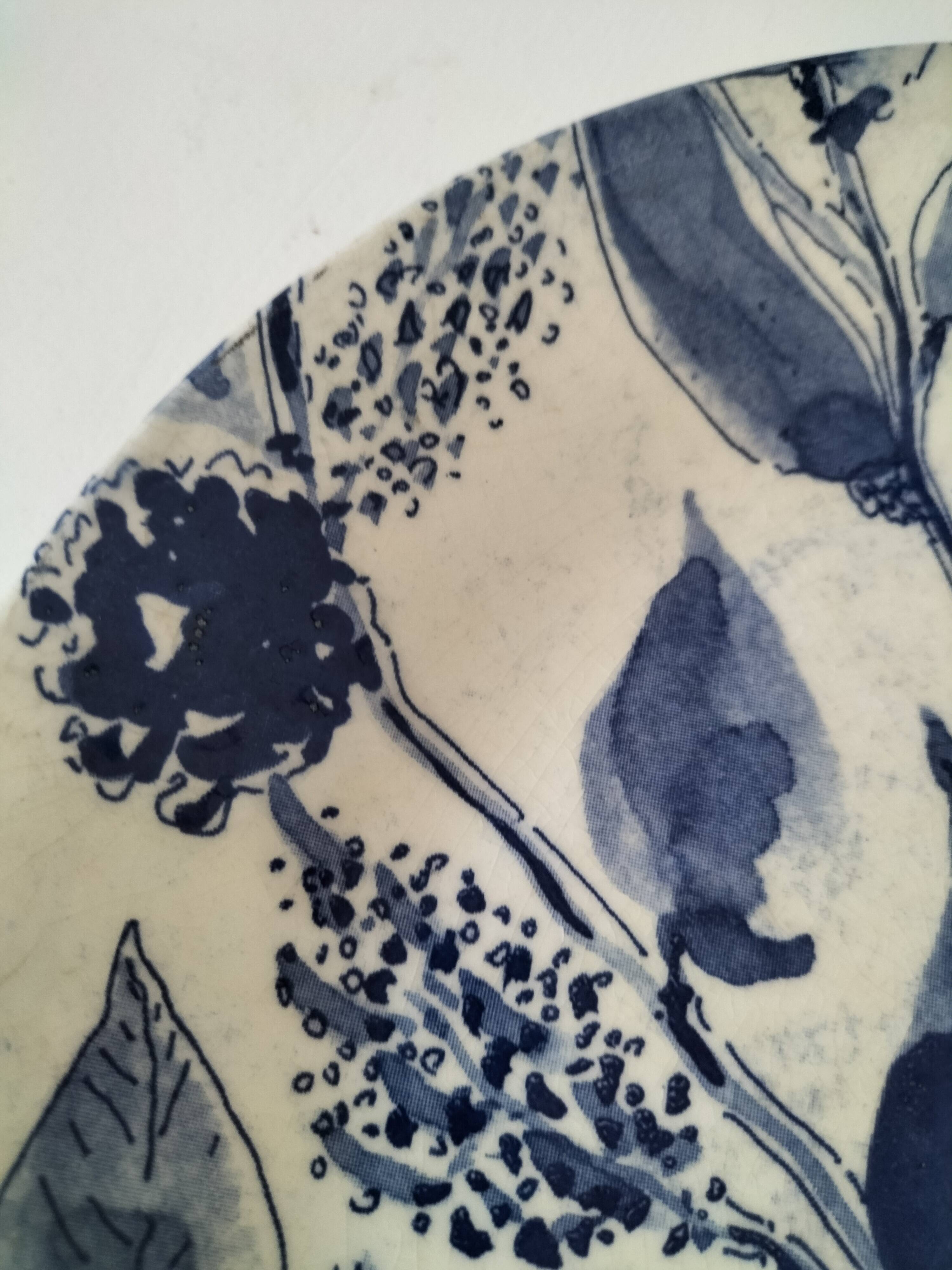 Two flat plates in earthenware with blue floral decoration.