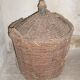 Old glass in her wicker basket demijohn