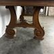 Renaissance-style oak dining table with lyre legs.