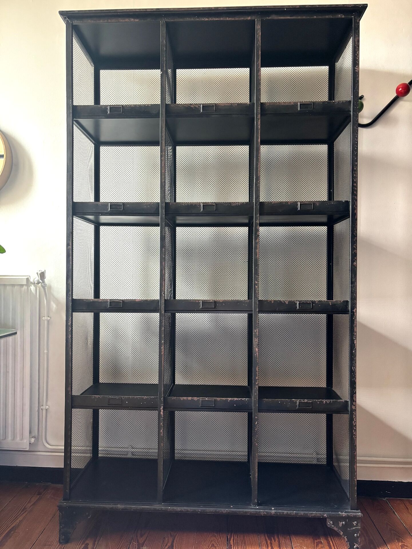 Black metal shelf with compartments.