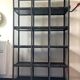 Black metal shelf with compartments.