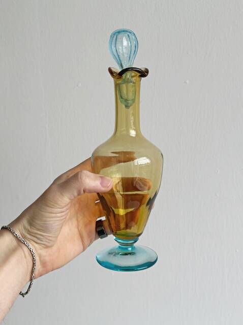 Old glass vial in yellow and blue.