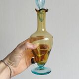 Old glass vial in yellow and blue.