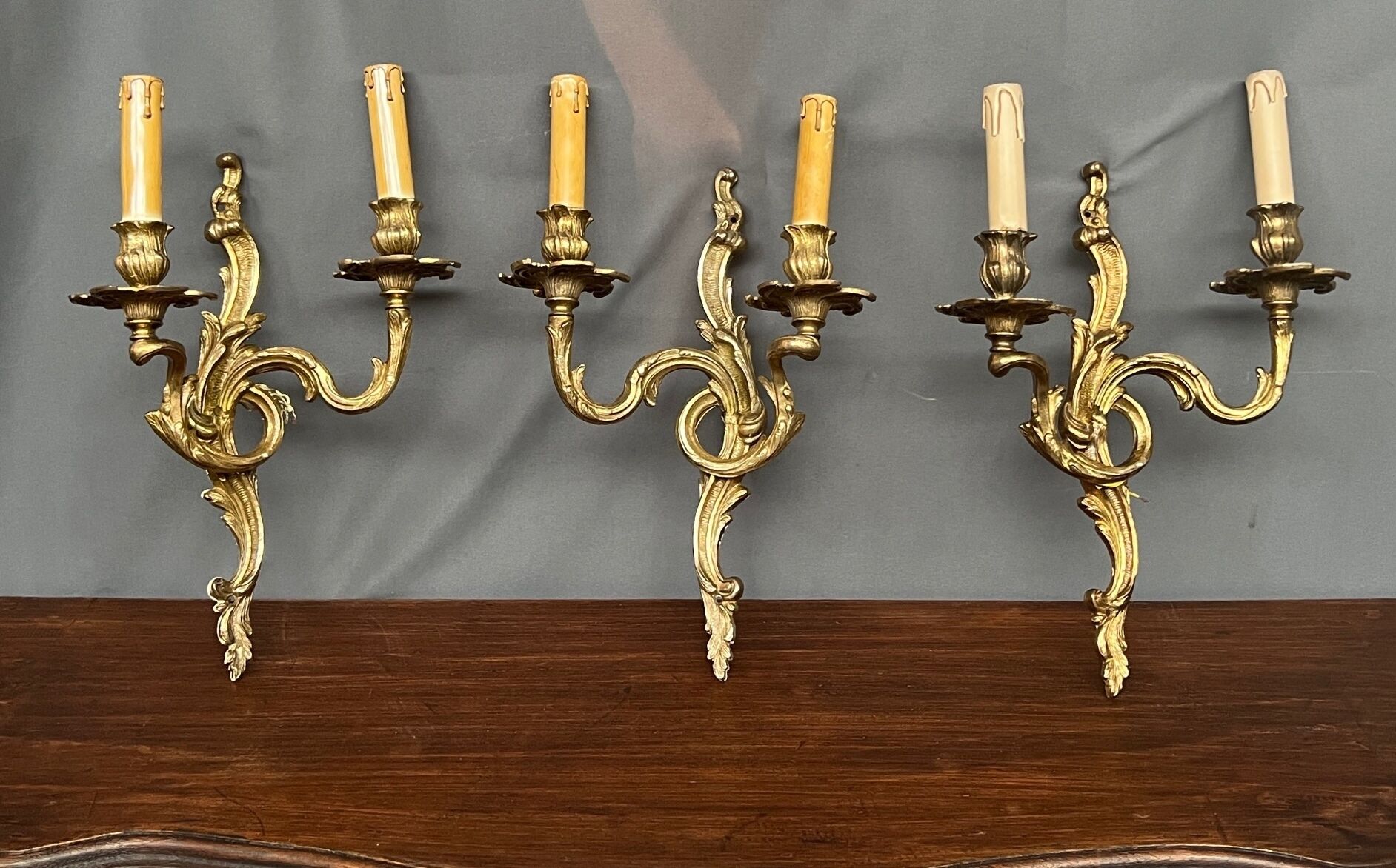 Set of three bronze wall sconces.
