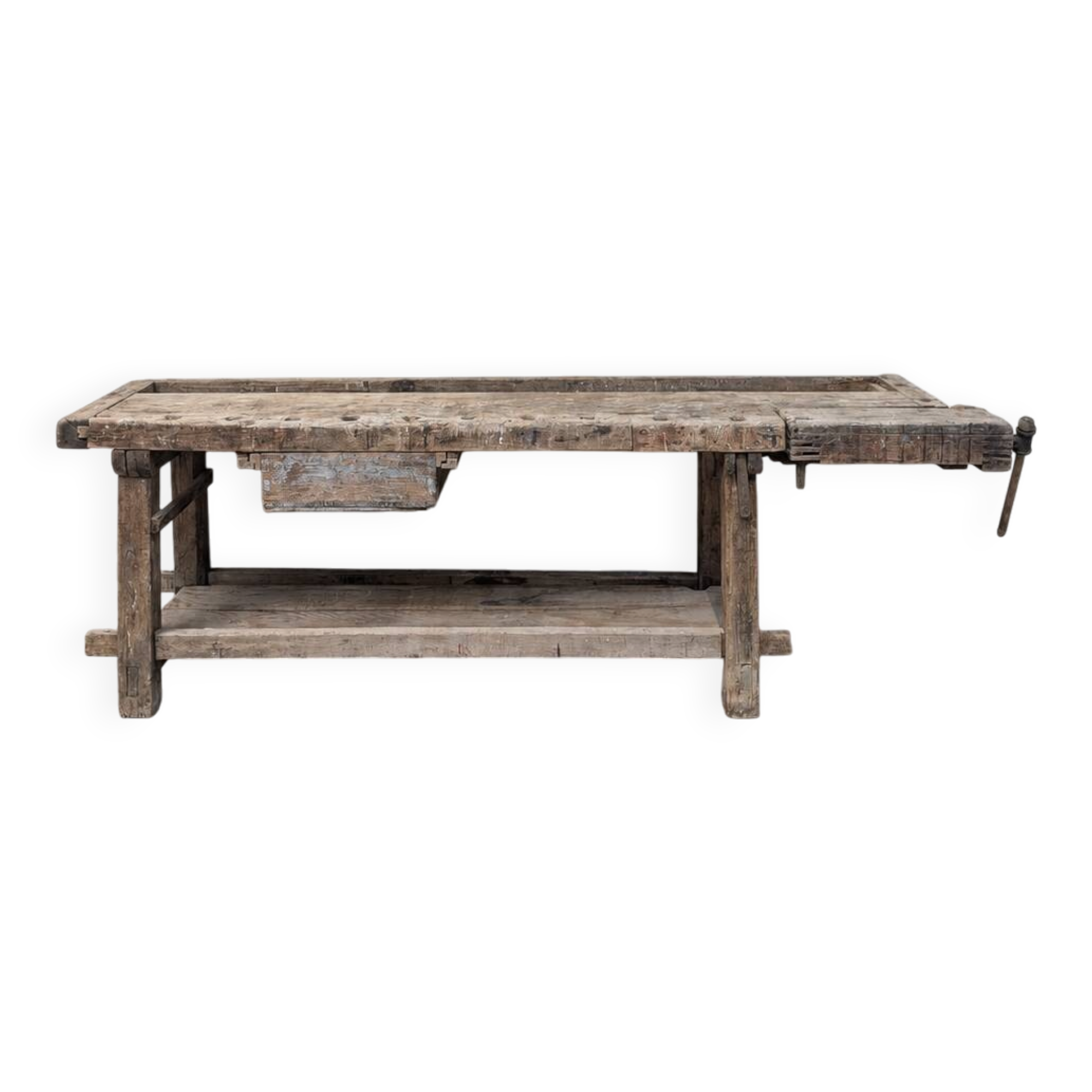 Antique wooden workbench with a vice and drawer.
