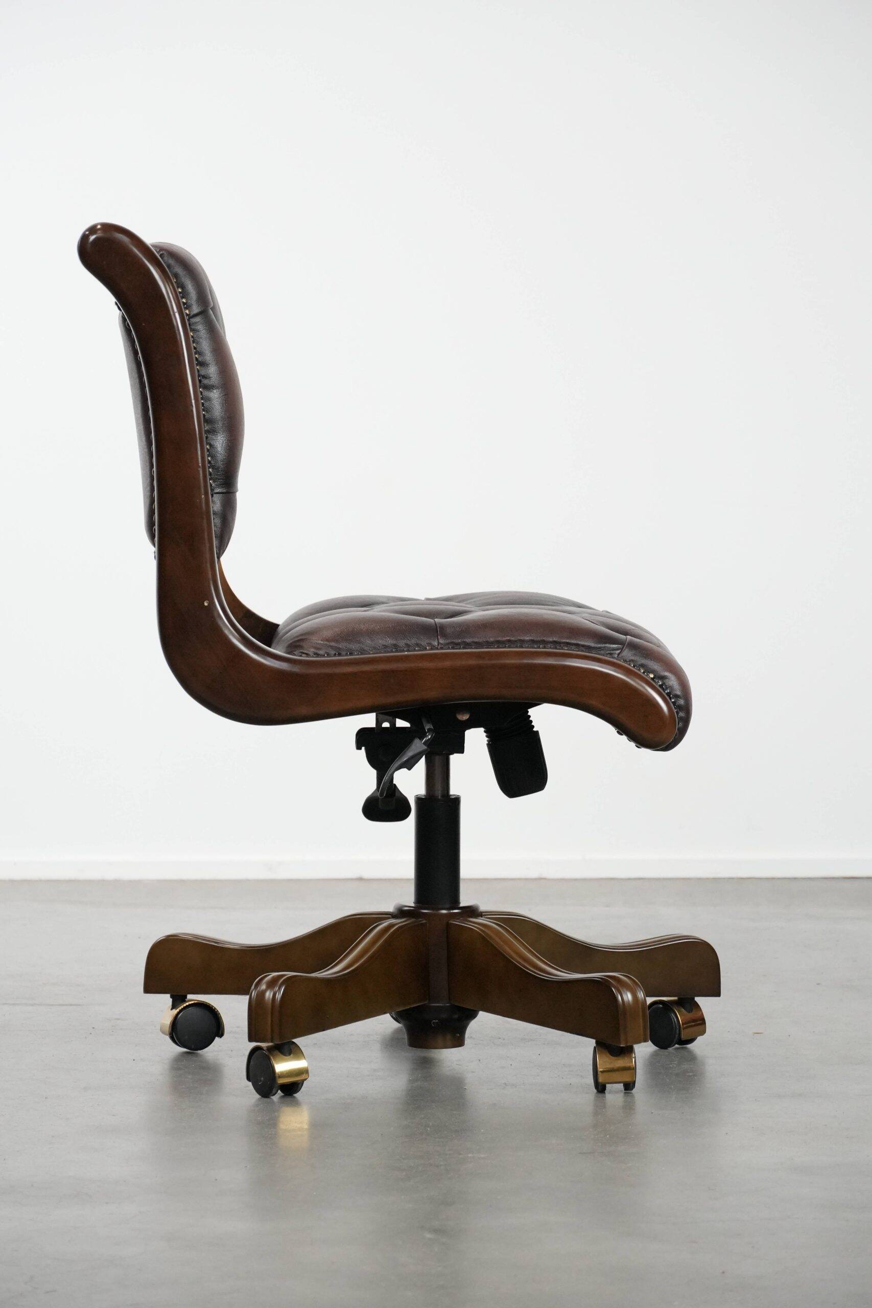 Chesterfield office chair in English style made of cow leather and wood.