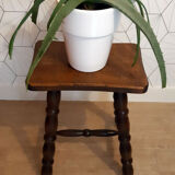 Brown turned wooden stool.