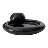 Vintage black ceramic candle holder on a bowl