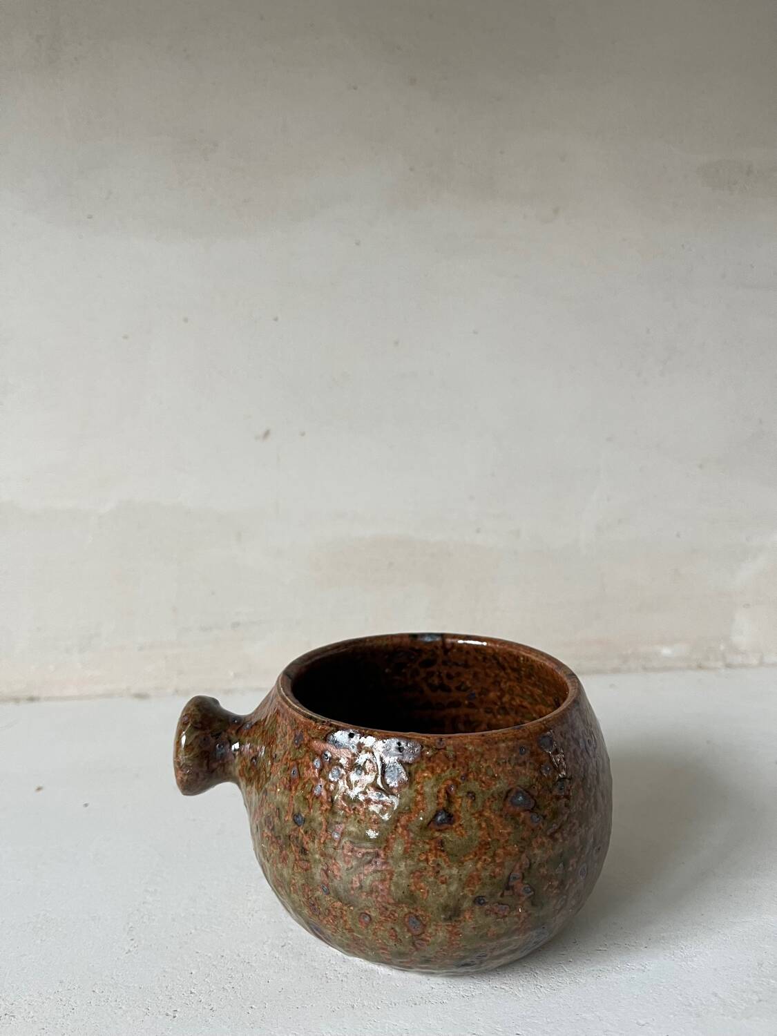 Old pyrite stoneware fondue pot