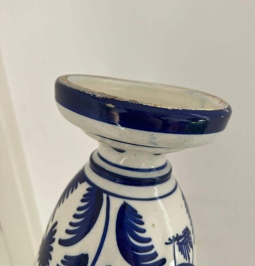 white amphora-style vase with hand-painted blue patterns
