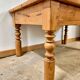 Antique coffee table in solid elm with turned legs.