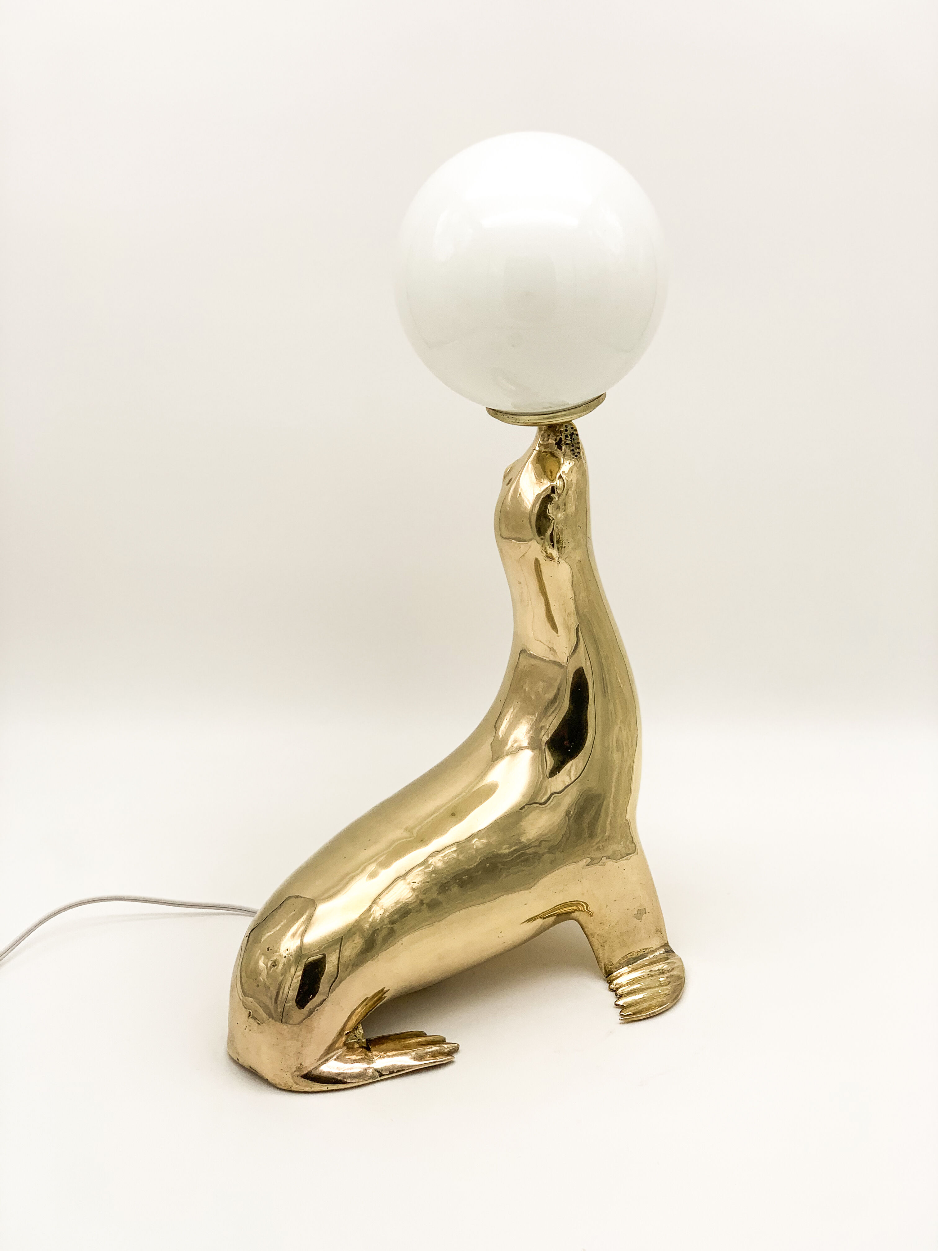 Vintage brass sea lion lamp
